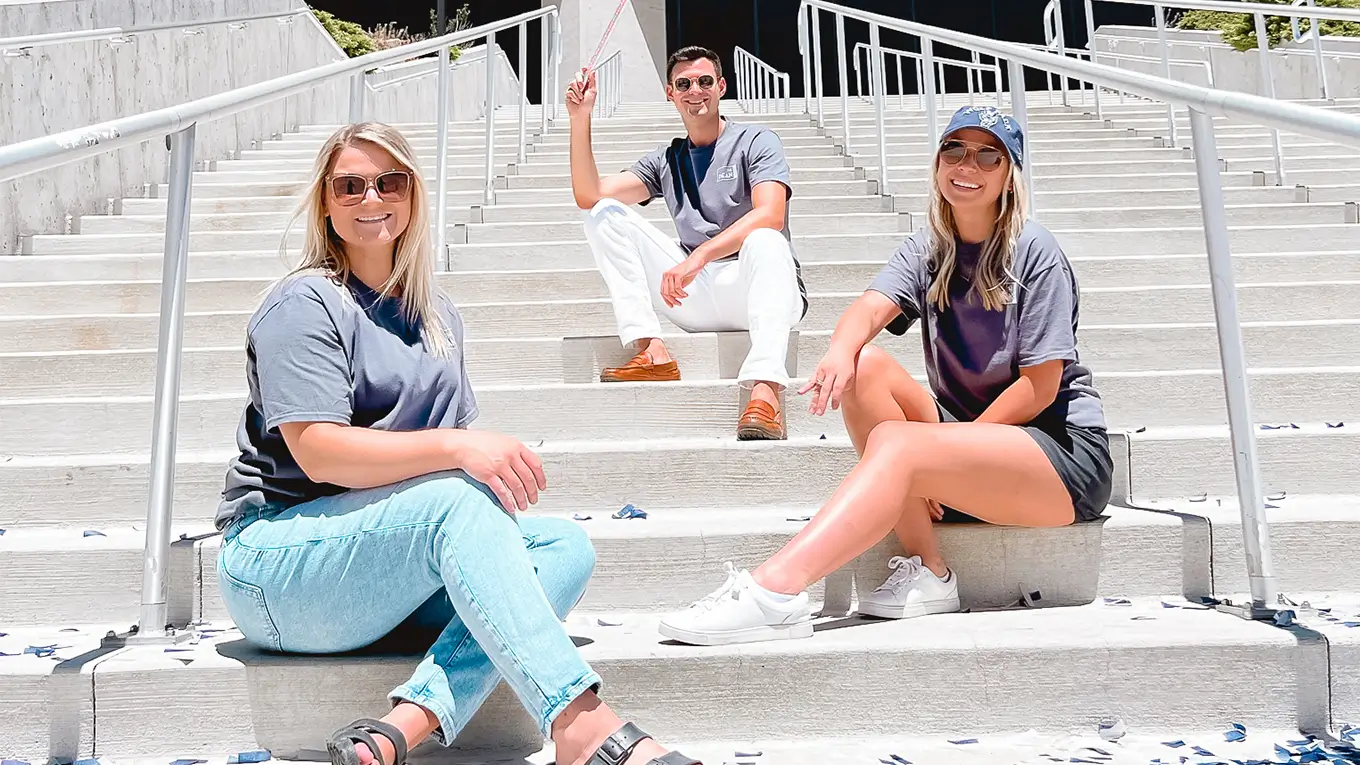 group of young adults sitting on stair steps
